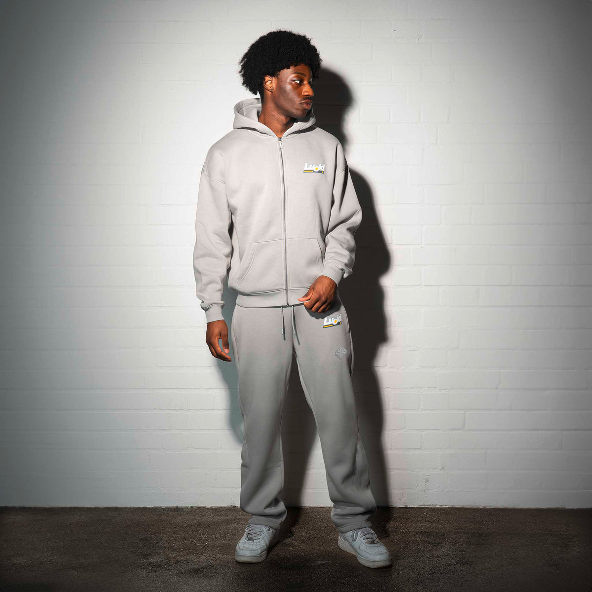 LOA Zip-Hoodie Grey on model in front of a white wall