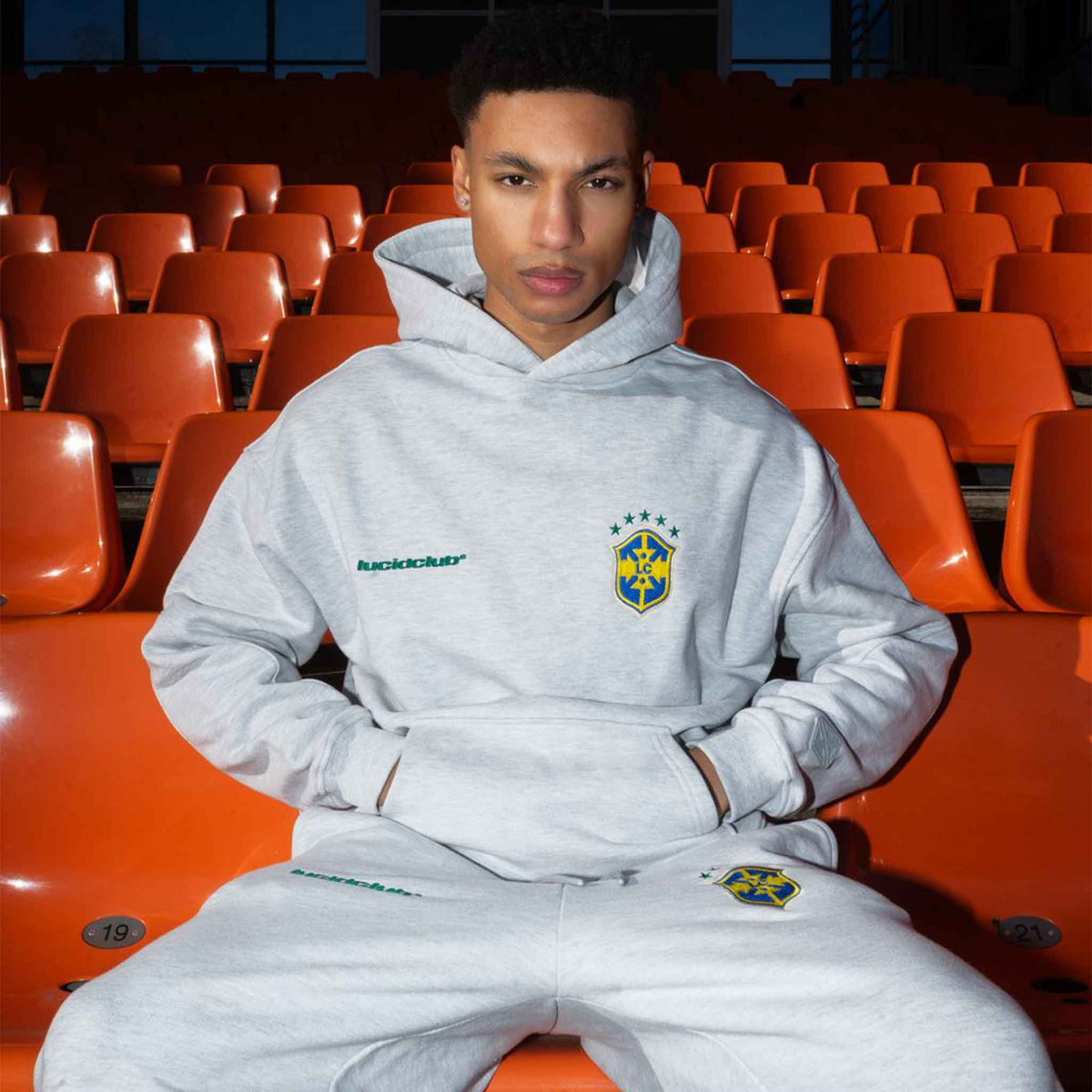 Brazil Hoodie Melange Grey on model in a stadium