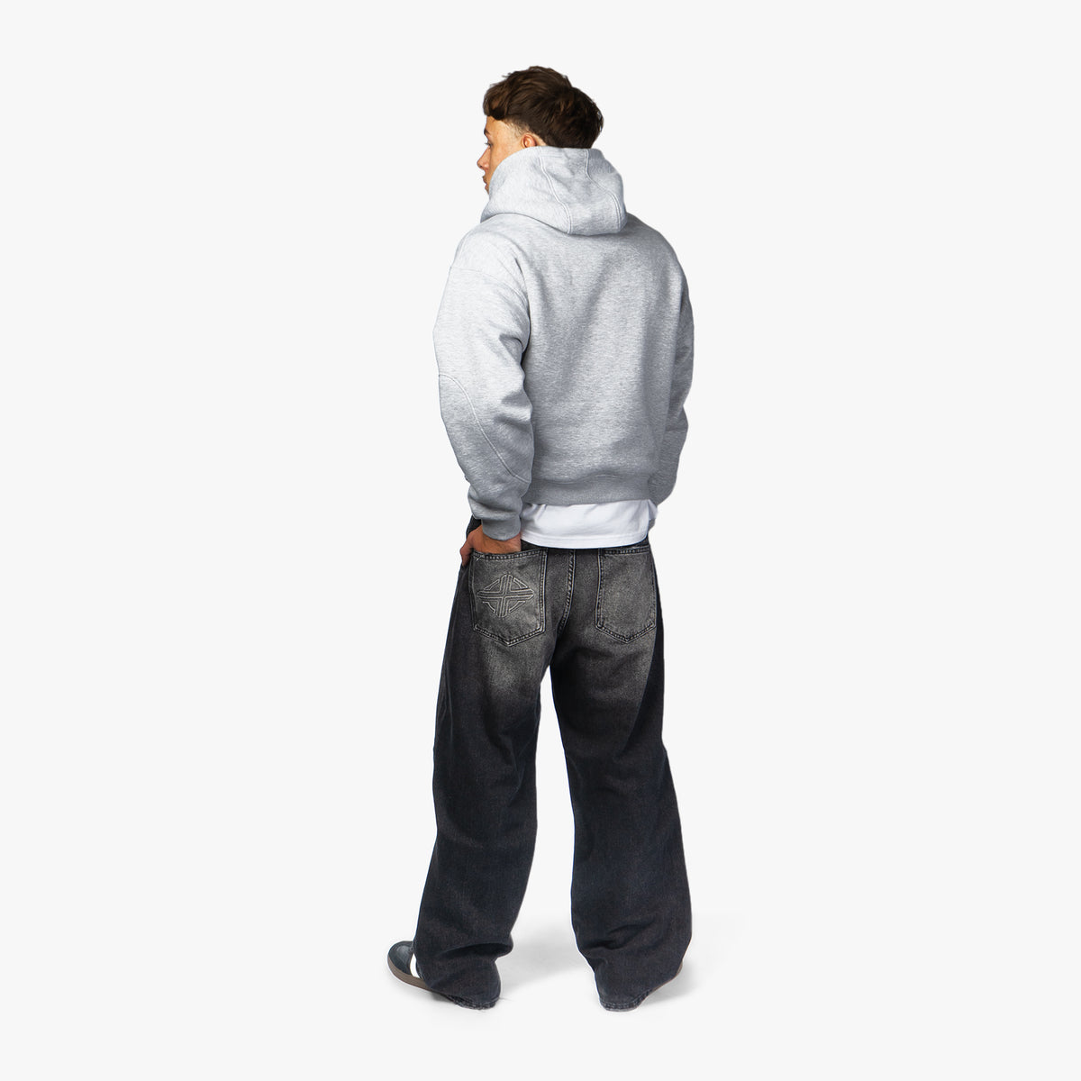 Star Denim Phantom Black on model, back view with grey hoodie
