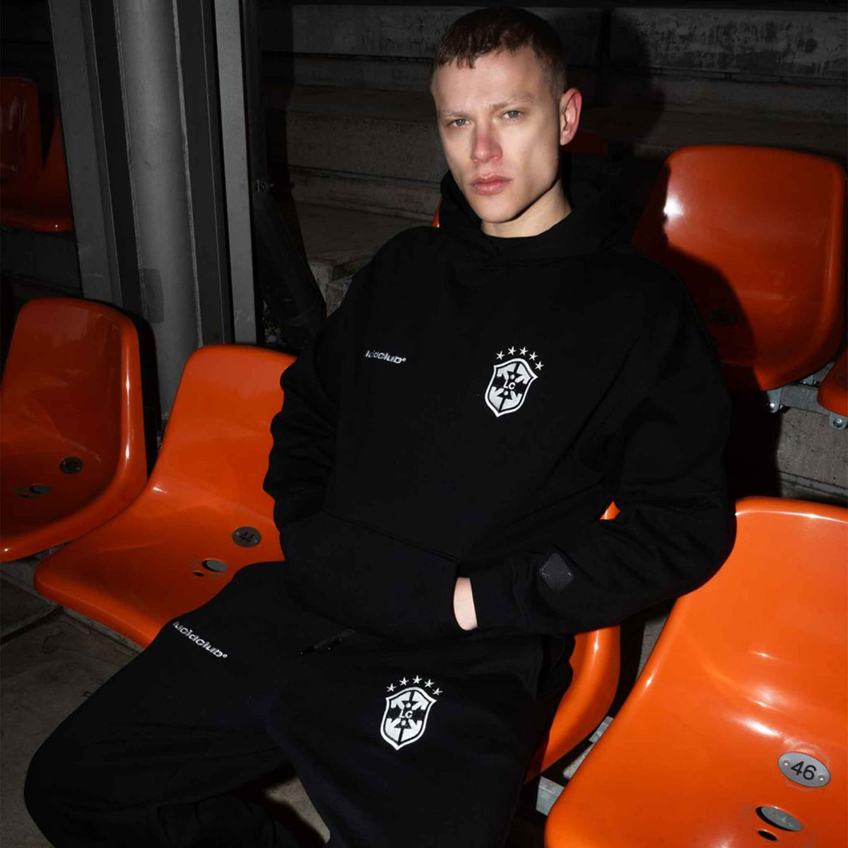 Brazil Hoodie Black on model in a stadium